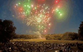 A fireworks display at Hyatt Regency Hill Country Resort and Villas with a crowd watching below.