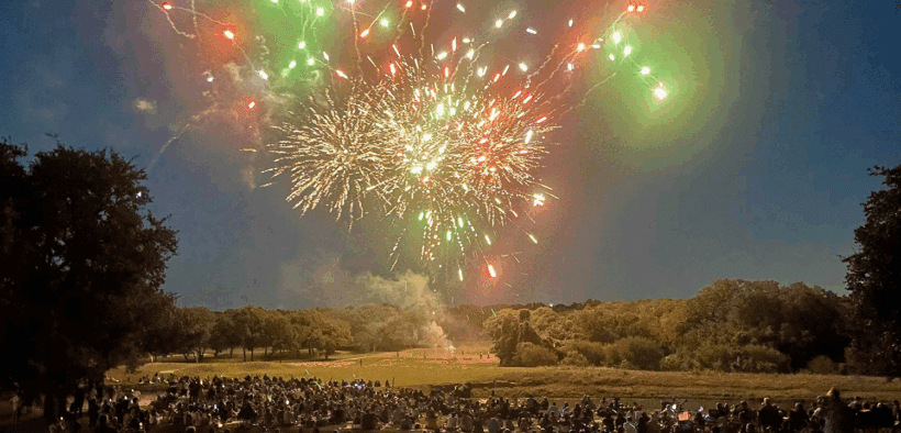 A fireworks display at Hyatt Regency Hill Country Resort and Villas with a crowd watching below.