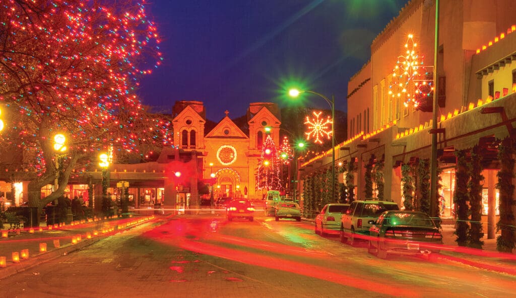 The Luminary at the Inn & Spa at Loretto resort lit up at night with holiday decor on the streets in Santa Fe, New Mexico.