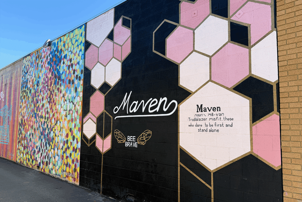 A mural of "Maven" with "Trailblazer misfit. those who dare to be first and stand alone." In Salt Lake City Maven District.