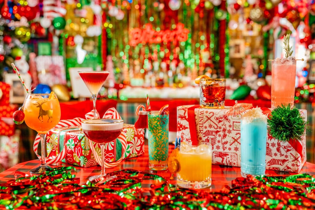 A festive table covered in cocktails, holiday gifts and tinsel at Prado, Omni Scottsdale Resort & Spa Montelucia.