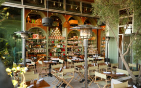 The outside patio of Songno Toscano with folding canvas chairs and trees in Phoenix.
