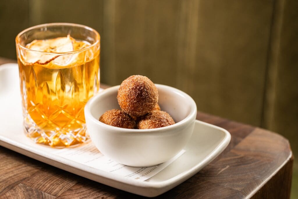 Cinnamon donuts and a Whiskey in a glass on a tray at The Henry in Arizona.