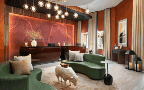 The lobby of Red Cliffs Lodge Zion with leather couches, sheep table and lobby desk in background.