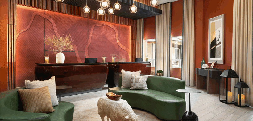 The lobby of Red Cliffs Lodge Zion with leather couches, sheep table and lobby desk in background.