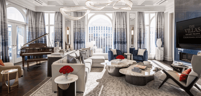Colosseum Presidential Villa living room at Caesars Palace with grand seating area, chandeliers and floor-to-ceiling windows.