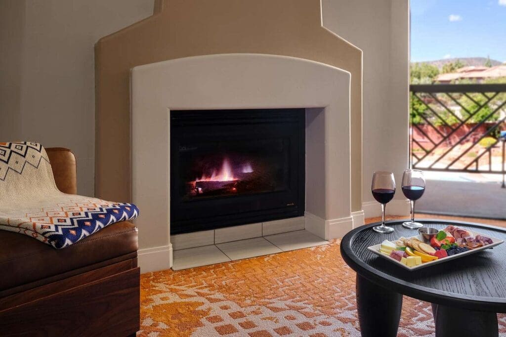 Guest room interior at Hilton Sedona Resort at Bell Rock with fireplace and patio views.