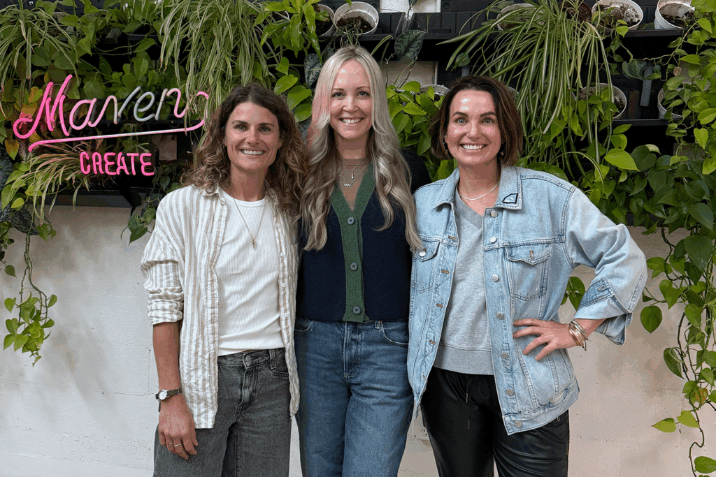 Tessa Arneson, co-founder of Maven District, Erin Thorburn, founder of The Best of the Southwest and Rocky Donati, co-founder of Maven District stand in front of a plant wall with a neon "Maven Create" sign.