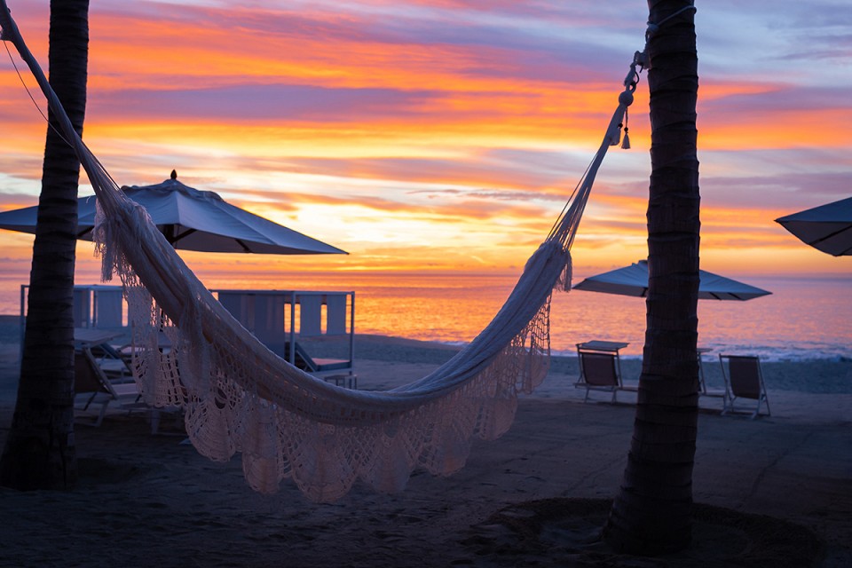Sunset view of hammocks and umbrellas next to the beasch at Garza Blanca.